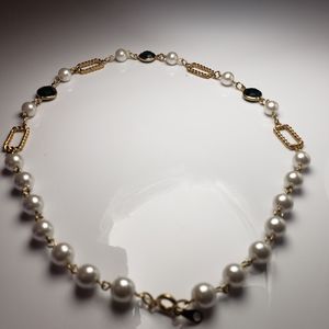 Pearl necklace with green accent stoned
